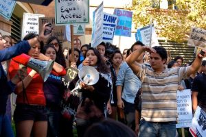 Students protest the UC Regents' proposed 32% fee hike. Pictured are various students leaders chanting with the crowd. A short-term goal of the protest was to be loud and disruptive enough outside of the UC Regents' meeting that the vote to approve the fee hike could not take place.