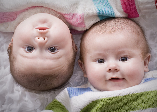 Twin babies laying next to each other