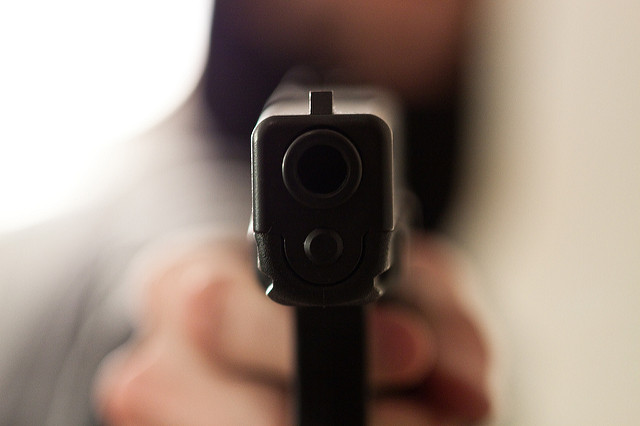 A robber holding a glock right up to the camera