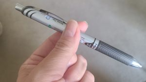 Photo of finger and thumb holding a pen