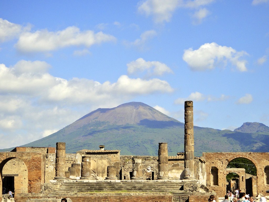 Stone and marble ruins of ancient city, with extinct volcano in background