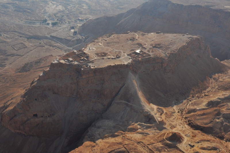 Aerial view of high flat mountaintop with ruins of structures on top