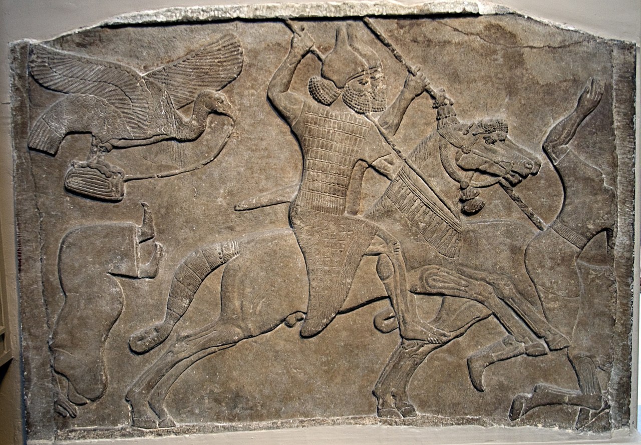 Piece of stone carving of soldier carrying spear on horseback, also images of beheaded victims and large bird following.