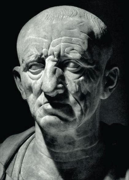 Marble bust of man's head, set with a grim expression.