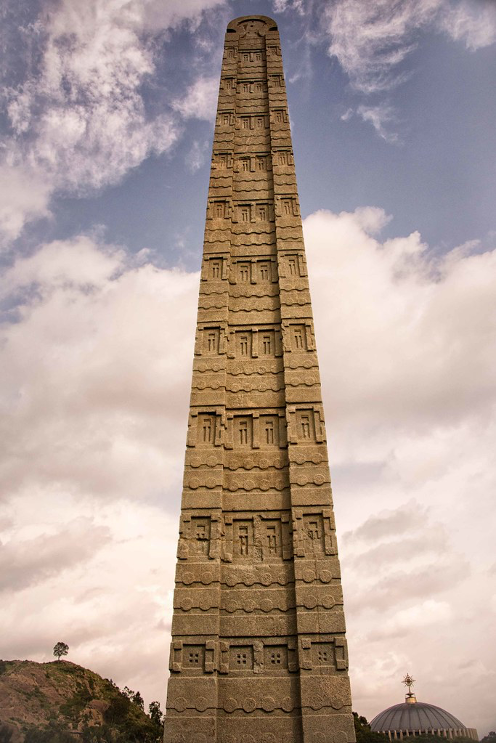 Tall structure made of stone with designs carved on it