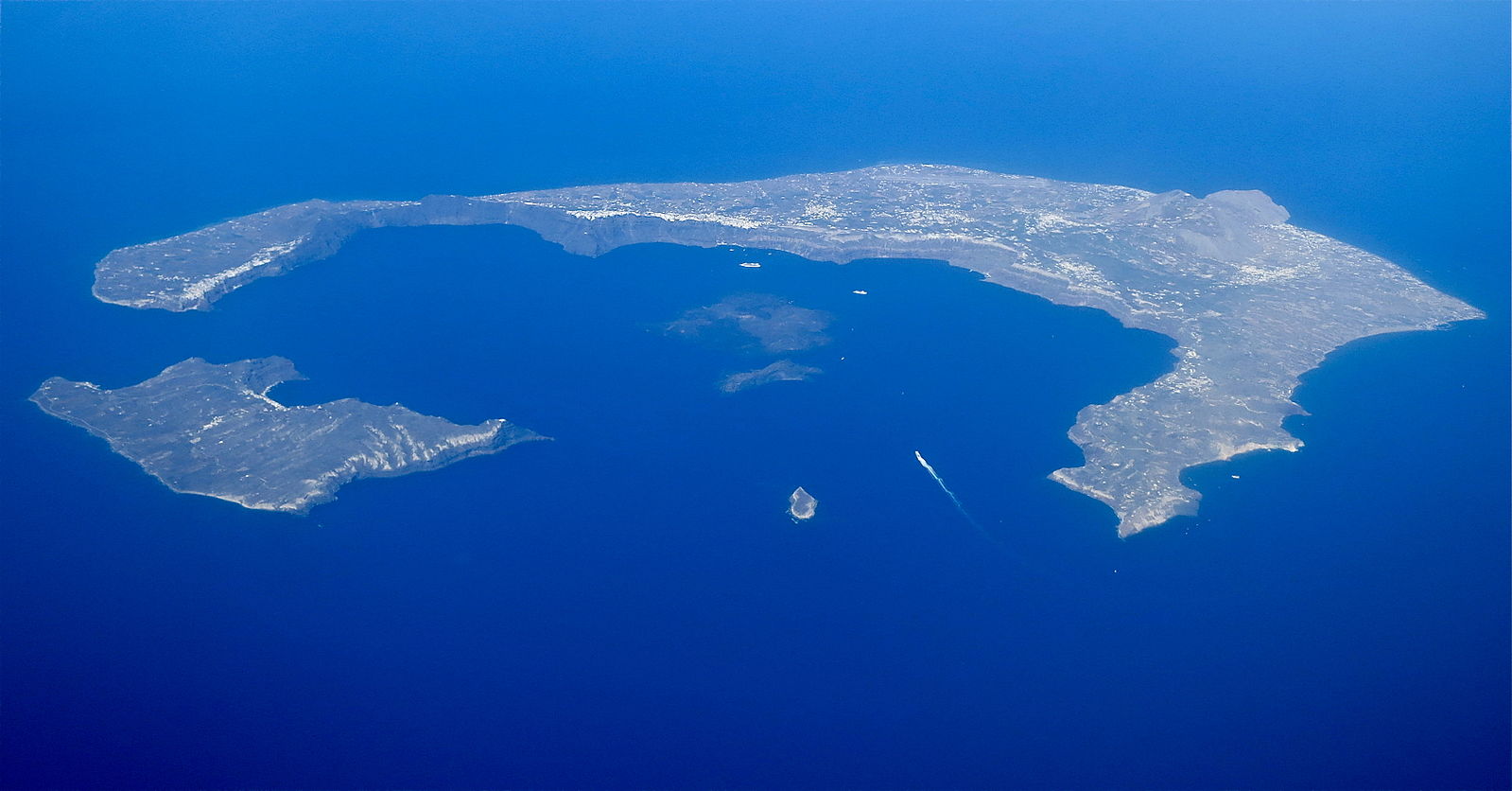 Two islands creating a semi-circle, surrounded by blue ocean