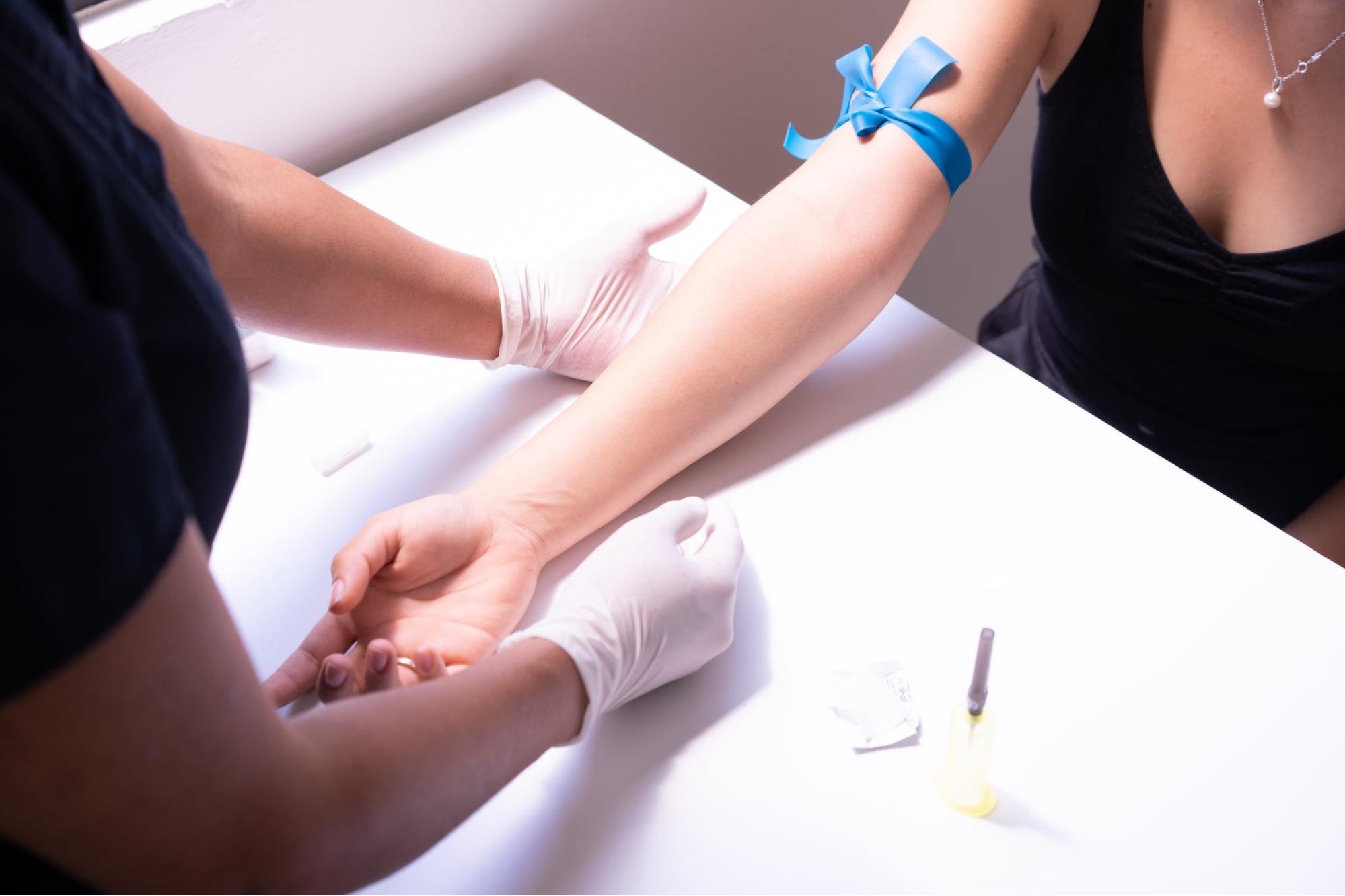 Patient’s arm with a tourniquet on ready for a blood draw.