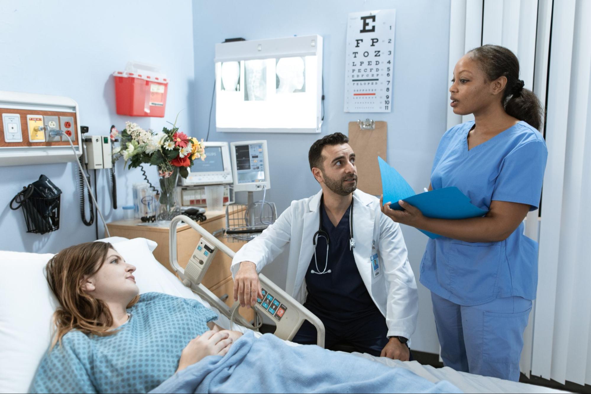 Healthcare team working with a patient who is hospitalized.