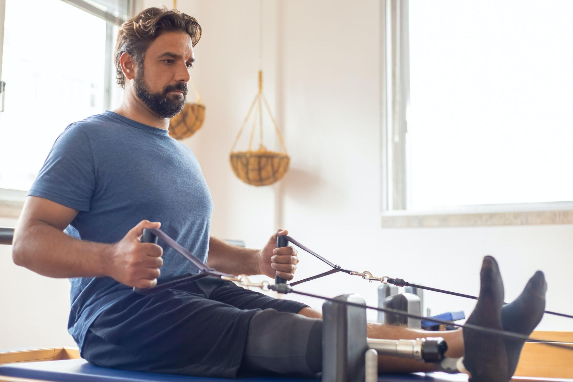 Patient using rehabilitation equipment in a rehab facility