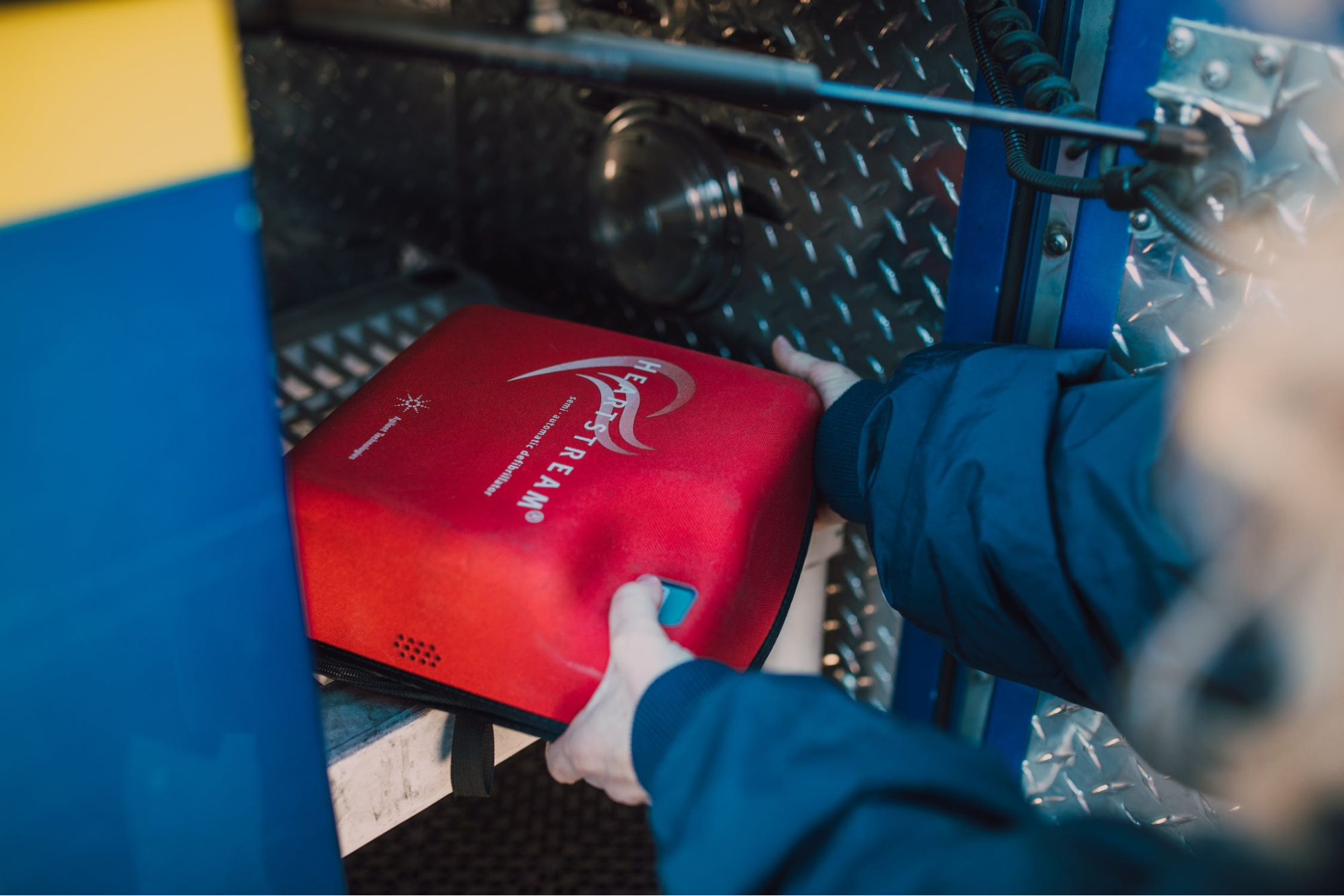 Medical professional removing an AED from the ambulance