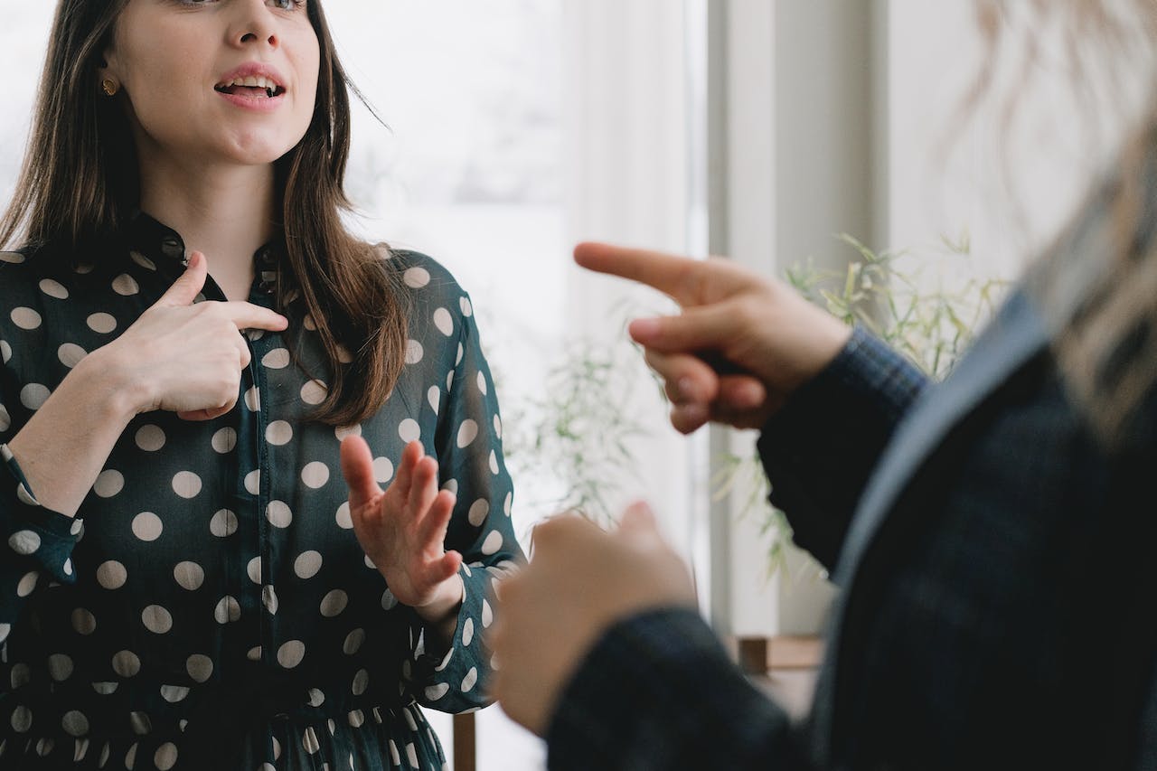 two colleagues pointing fingers during a disagreement