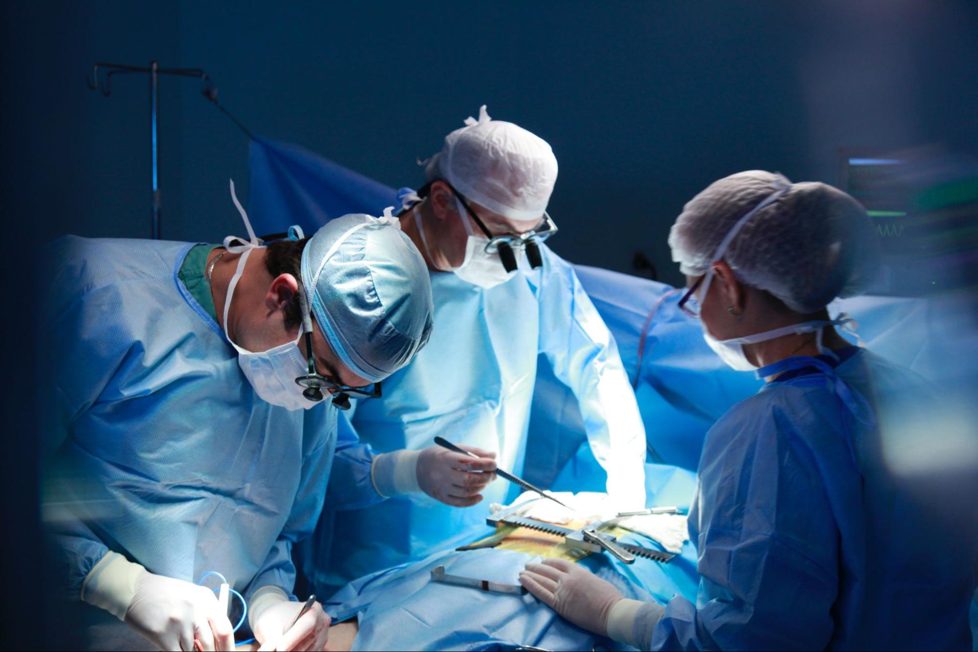 A team of medical professionals are working on a patient in an operating room