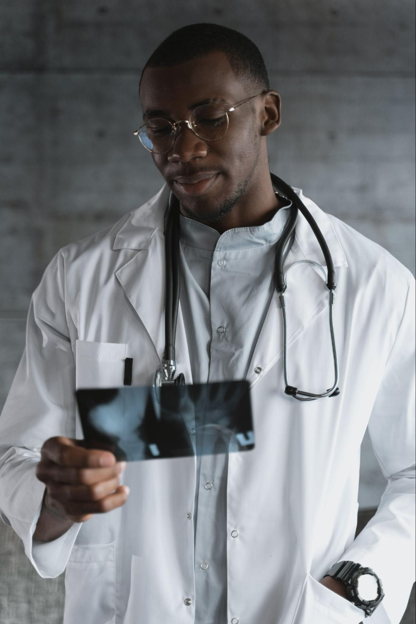 Healthcare professional holding and x-ray looking and looking at the image