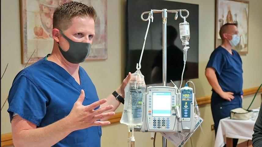 Healthcare professional standing next to medical equipment