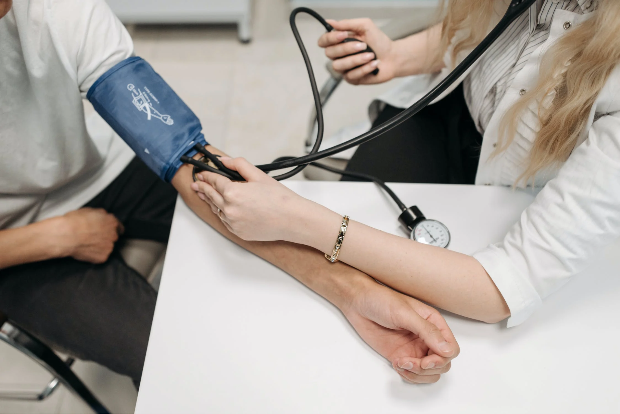 Healthcare professional taking a manual blood pressure