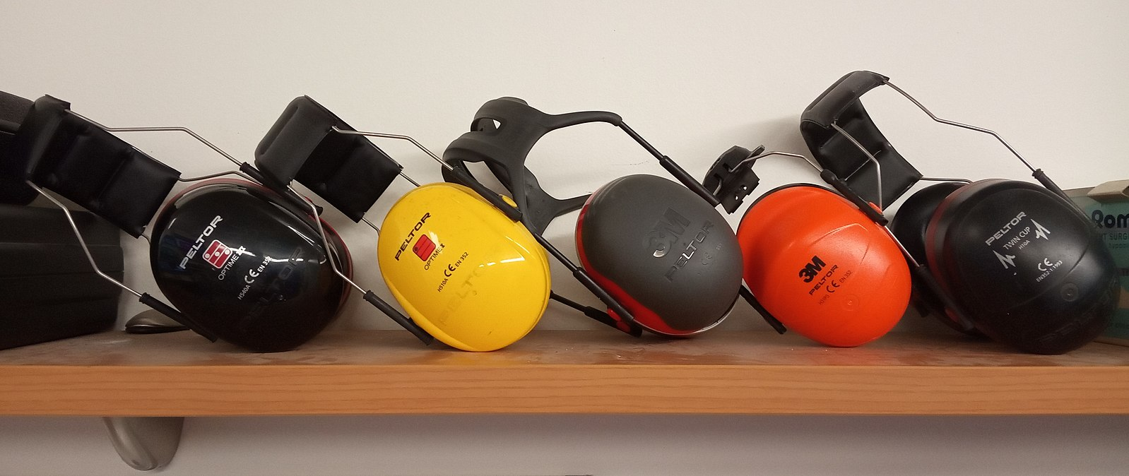 A colorful display of several pairs of over the ear noise protection or ear muffs