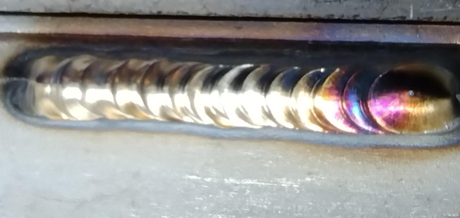 GTAW weld on stainless steel with a hay like color particularly on the right-hand side of the image.