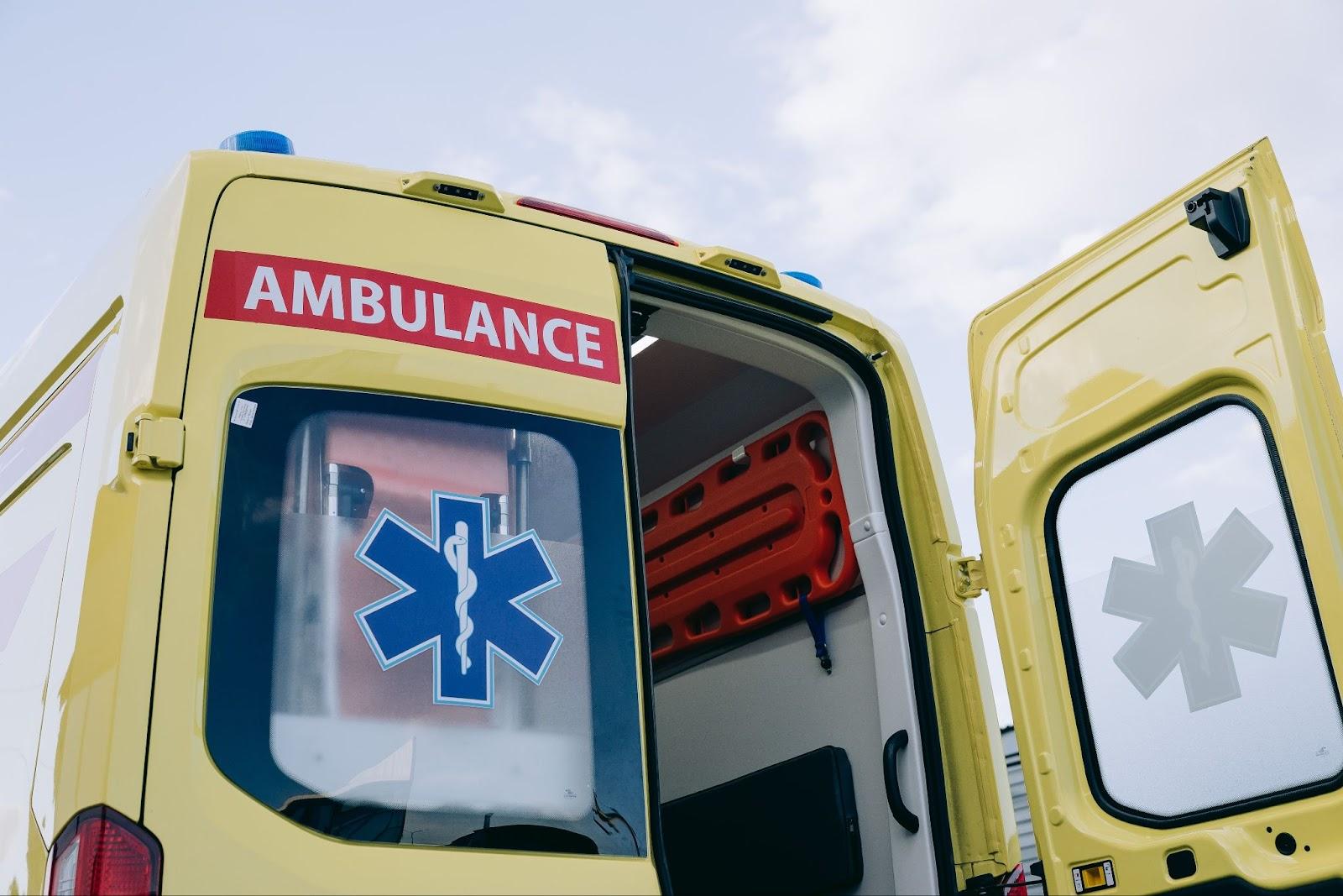 The rear of an ambulance with the back door open.