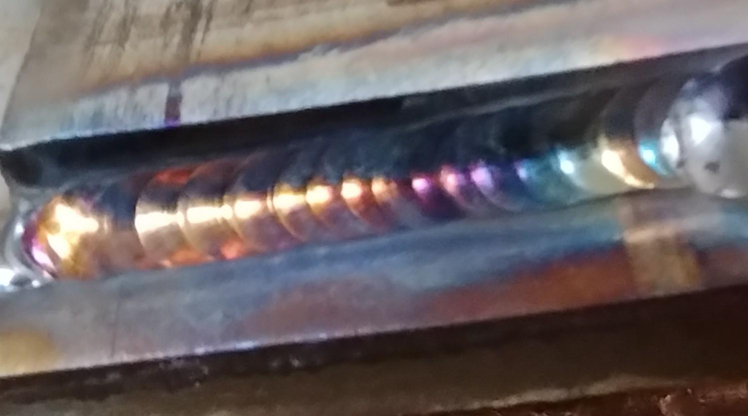 GTAW weld on stainless steel with deep purple color indication of high heat input.