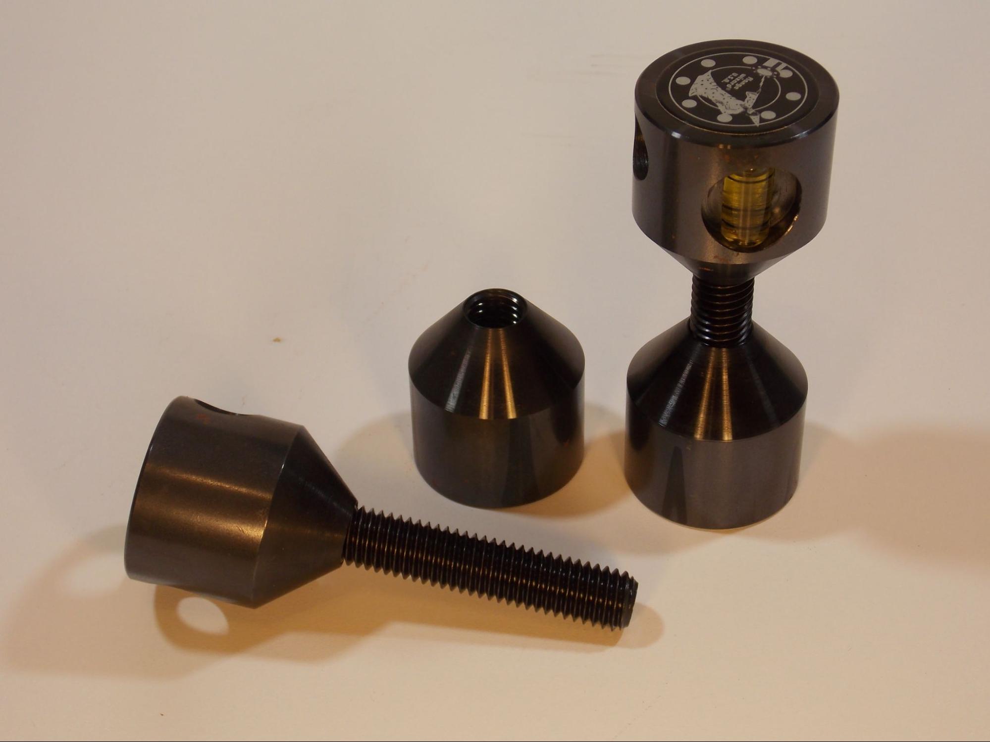 A set of two hole pins, which are two large screw threaded bars with large cylindrical heads that can be screwed onto either end. One end of each cylinder is flat and the other end is conical in order to nest into the bolt hole of a pipe flange. A level is embedded in on head of each tool.