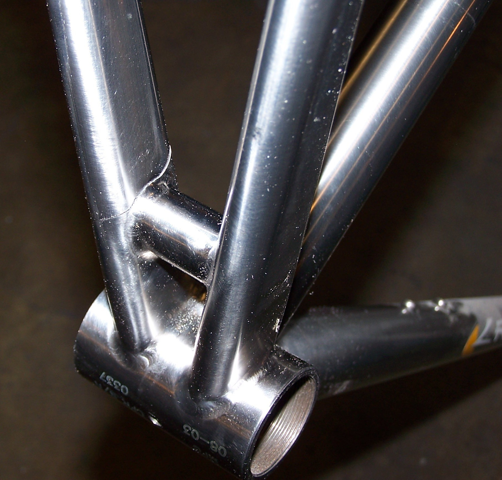 A bike frame with a thin crack above the axle of the bike.