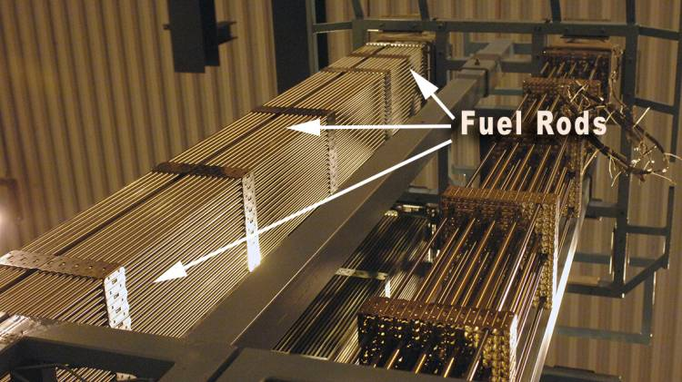 Nuclear fuel assembly consisting of 12 foot long tubes in a 17x17 array that is held together by spacer grids and mixing vanes which look like rectangular straps at intervals axially.