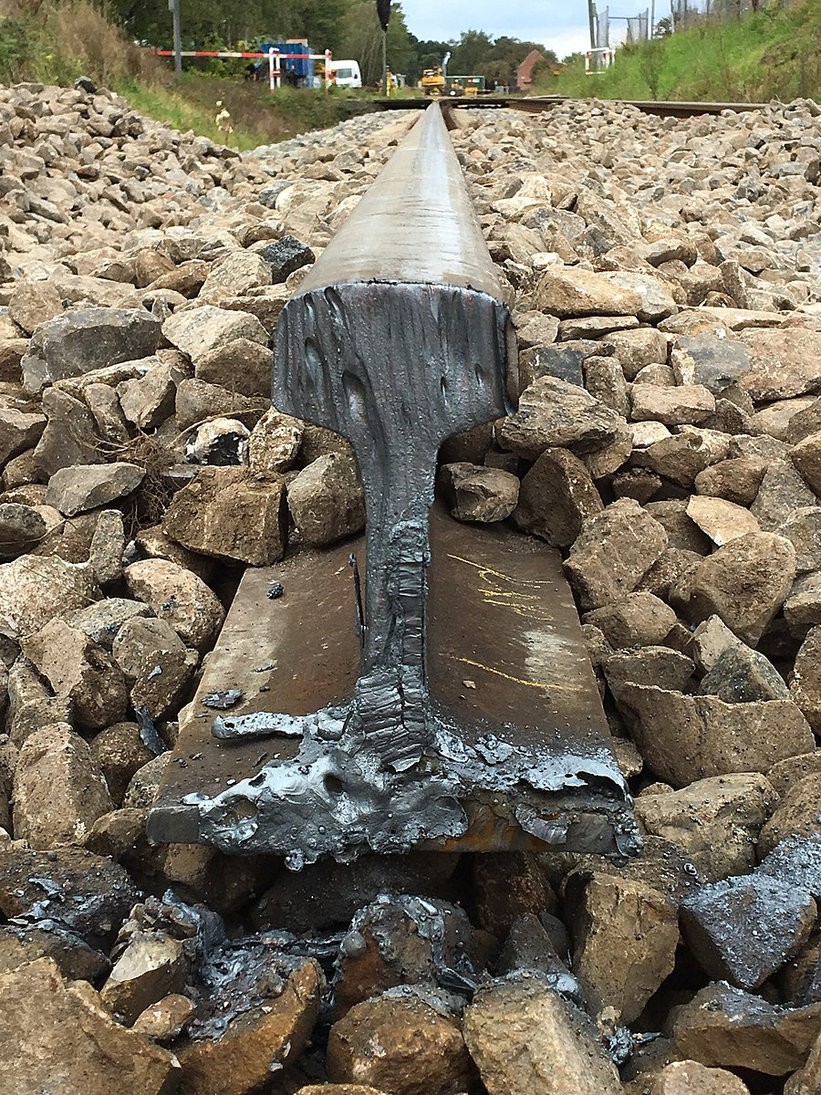 Railroad rail cut on the end with oxy-fuel. The cut shows some melted metal toward the base of the cut, and the edge looks a bit like melted wax on a candle, showing how oxy-fuel cutting heats the metal in order to cut through it.