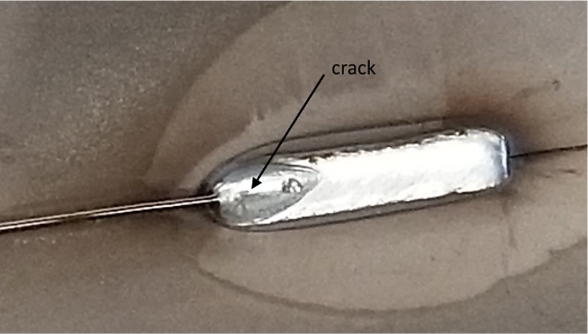 Crater Crack at the end of a weld bead in a common location. Crater cracks and how they appear is described in the preceding text.