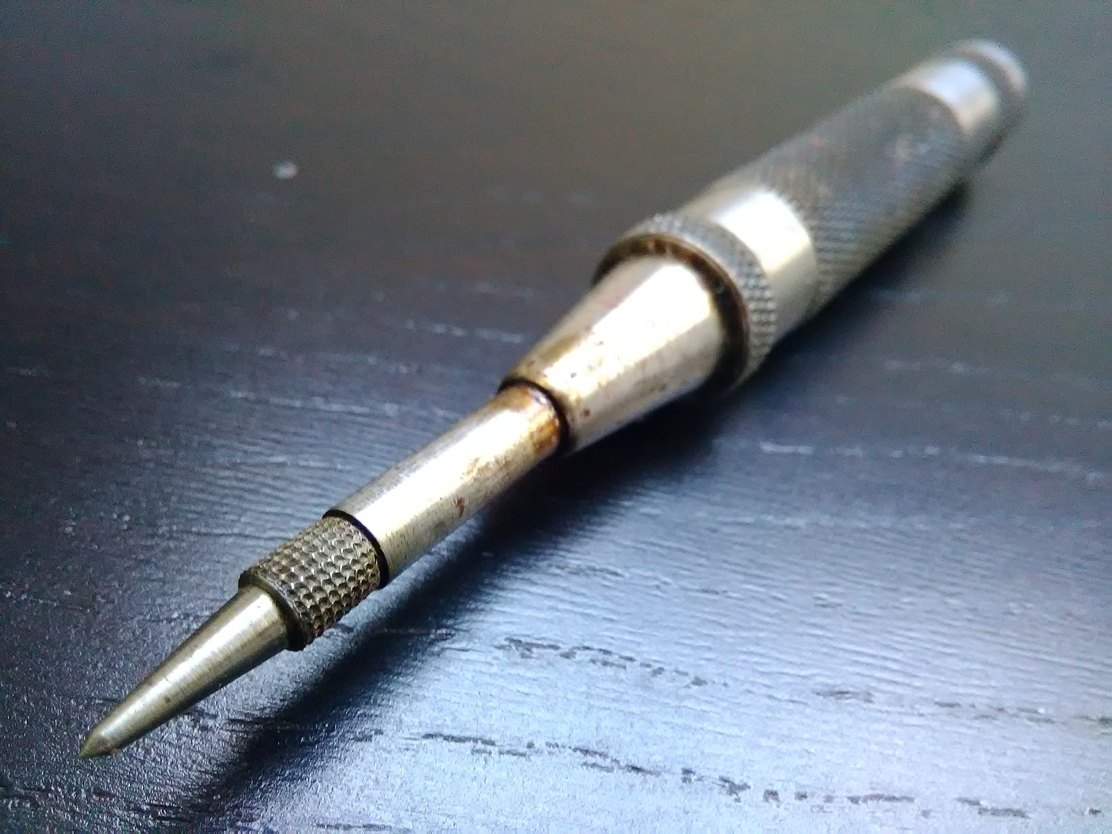 A spring-loaded center punch