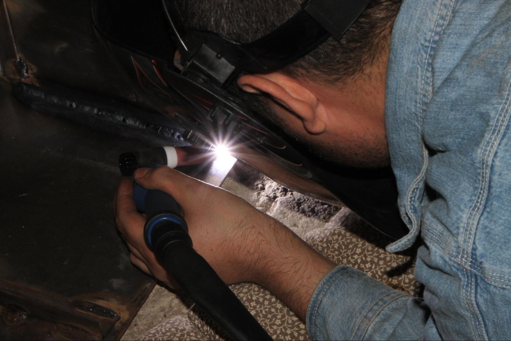 A welder uses GTAW to make a weld on steel plate.