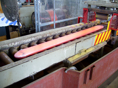 Rolling a hot ingot results in the ingot being compressed into a longer, thinner piece of metal. This piece is shaped a bit like a longsword without the sharp edges.