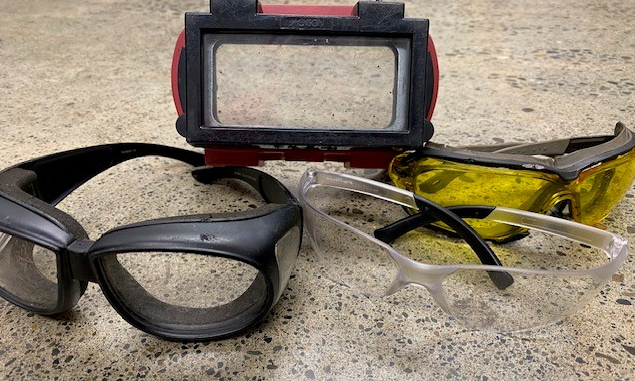 Four different types and styles of safety glasses or eye protection.