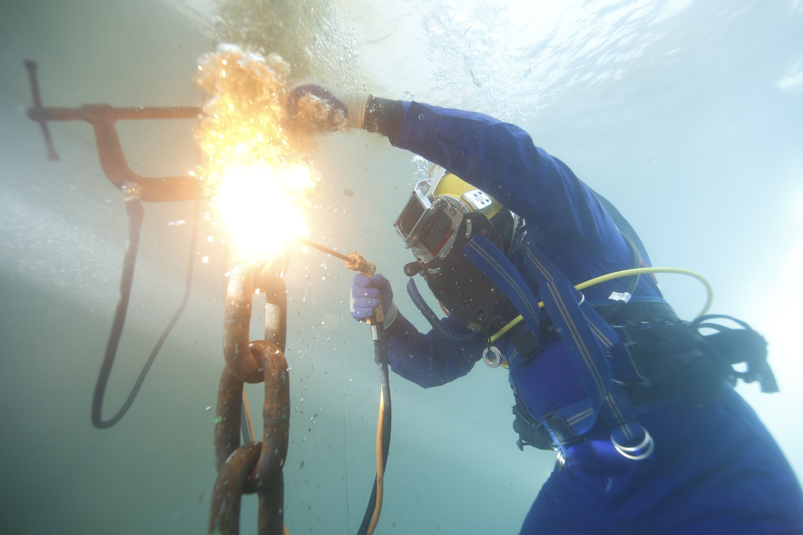 An underwater welder works in PPE especially designed for their environment and task.