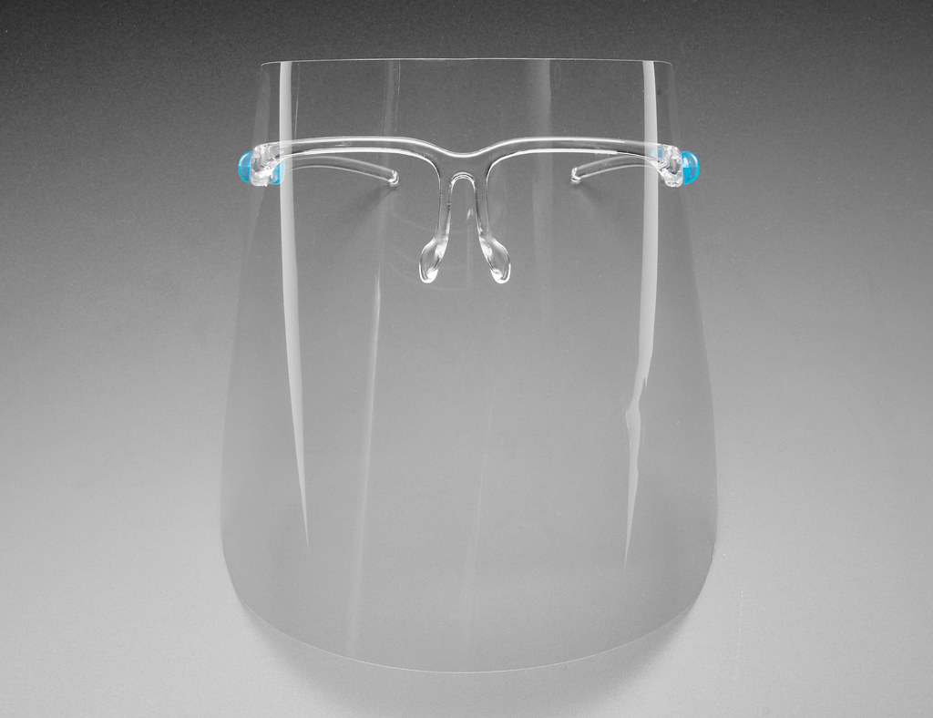 A clear face shield with glasses style head gear