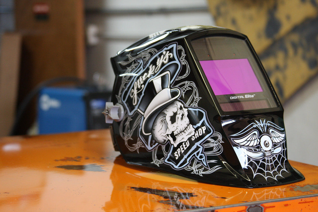 An auto-darkening welding helmet with graphics painted on the front and sides.