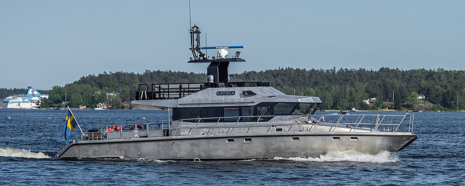 A boat, moving through the water, it is made of aluminum.