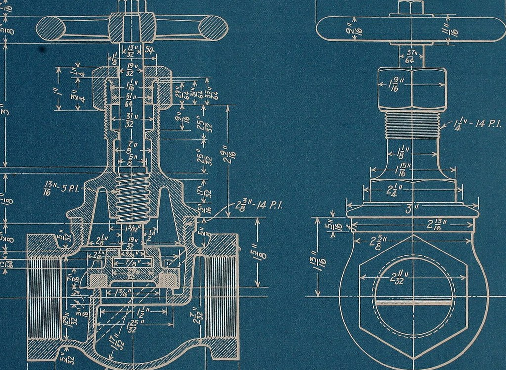 A traditional blueprint made in the 1900s of a piece of machinery showing measurements in inches and fractions of inches.