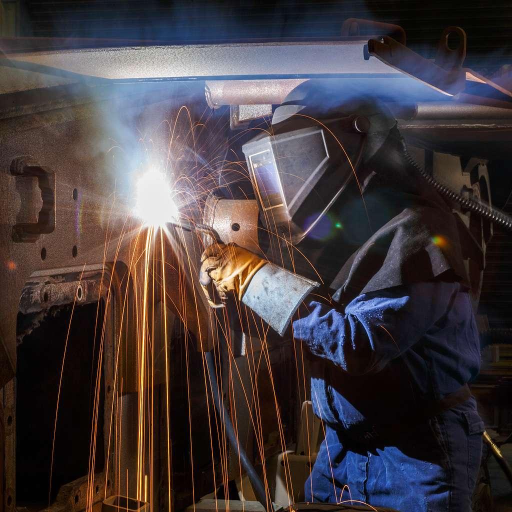 Image of a welder performing flux cored arc welding