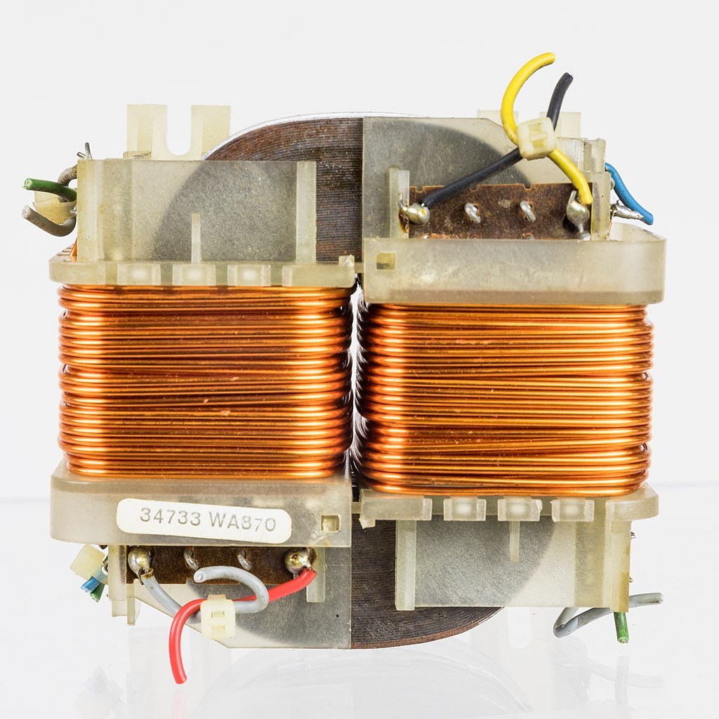 A common transformer made of an iron core in the shape of a square, with primary and secondary windings of copper wire around opposite sides.