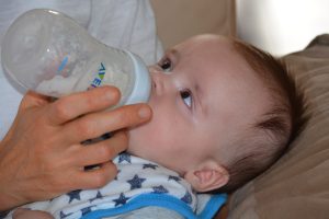 Baby being bottle fed