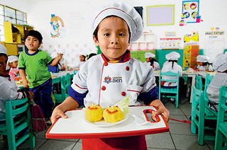 Child presenting food on a tray