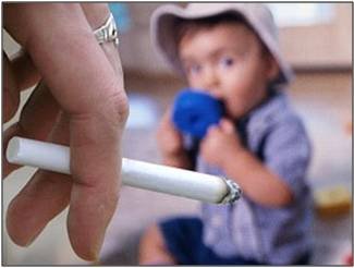 Lit cigarette with child in background