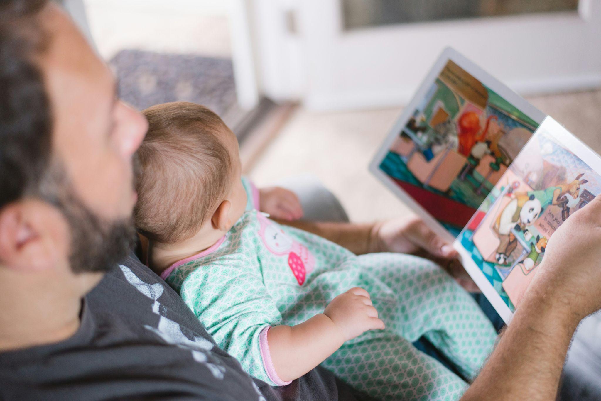 Father and child looking at a book.