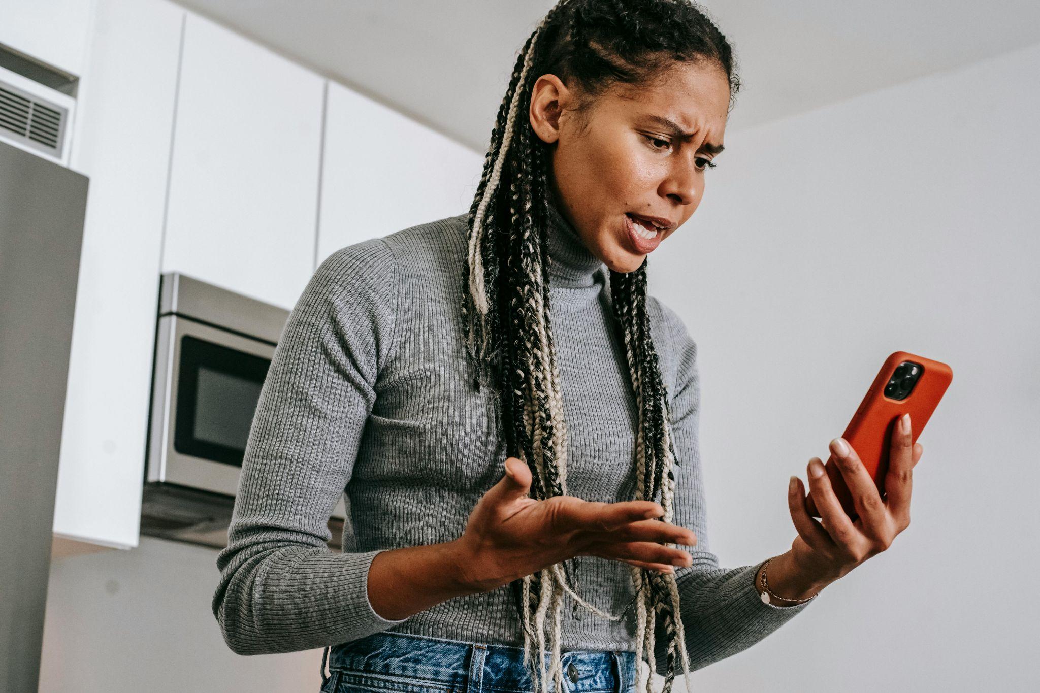 Woman on phone is annoyed. Photo portrays intent vs. impact (intent of the conversation had a different impact on the listener.