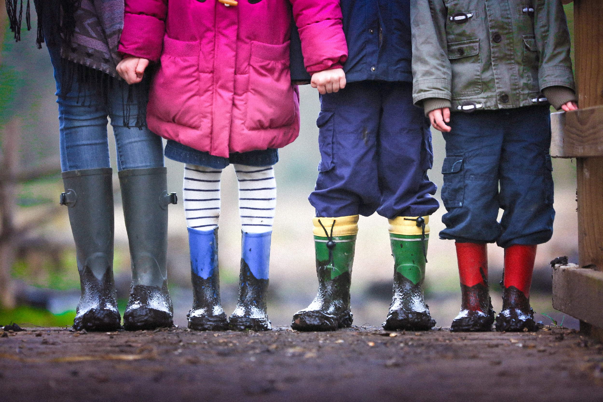 A group of 4 children holding hands to illustrate relationships, as well as partnership.