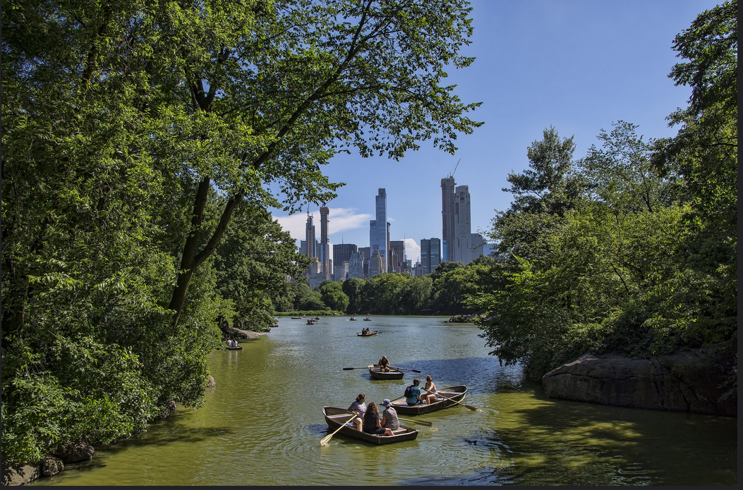 Tourists taking canoe rides in Central Park, New York.