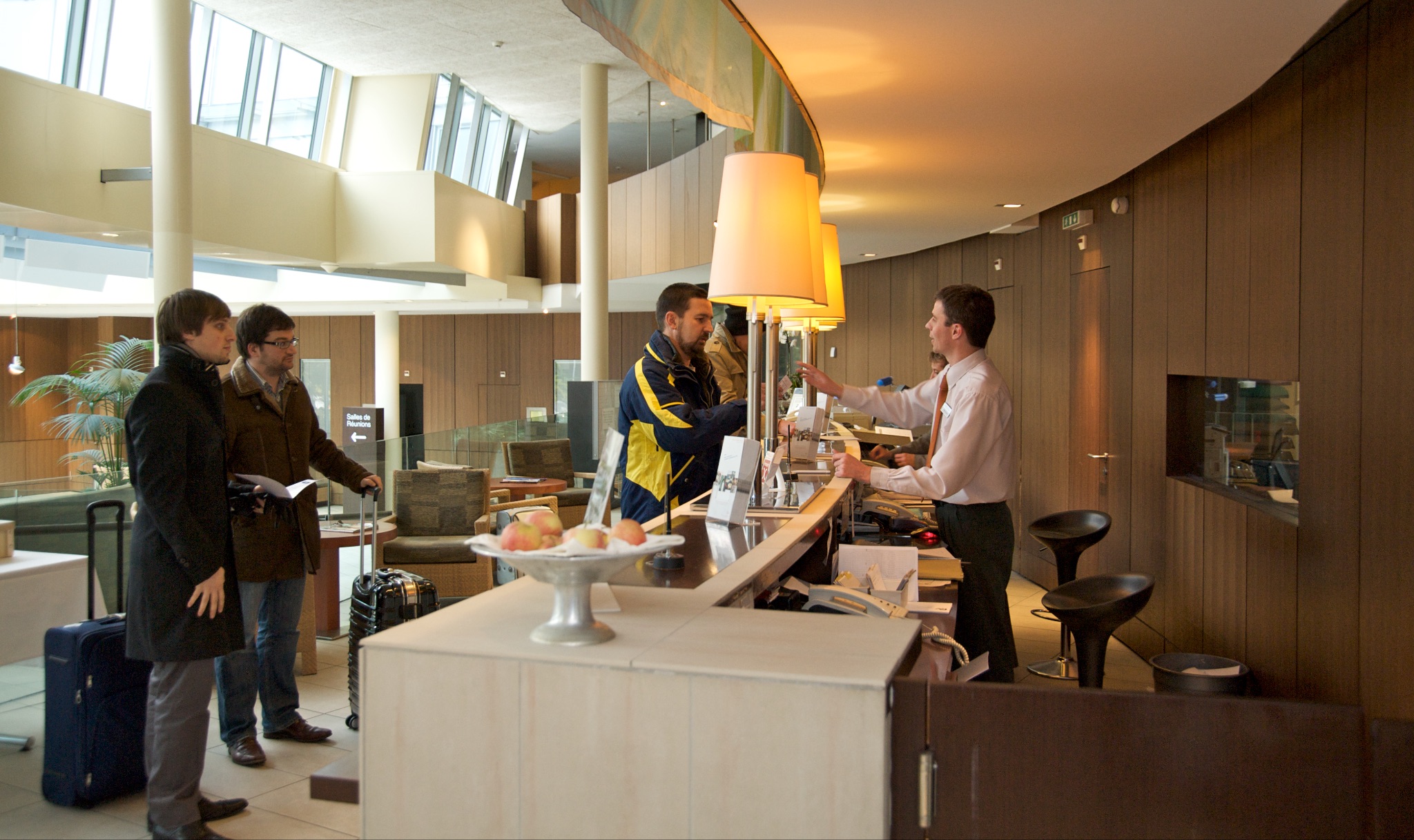 Hotel staff facilitating guest check-in.