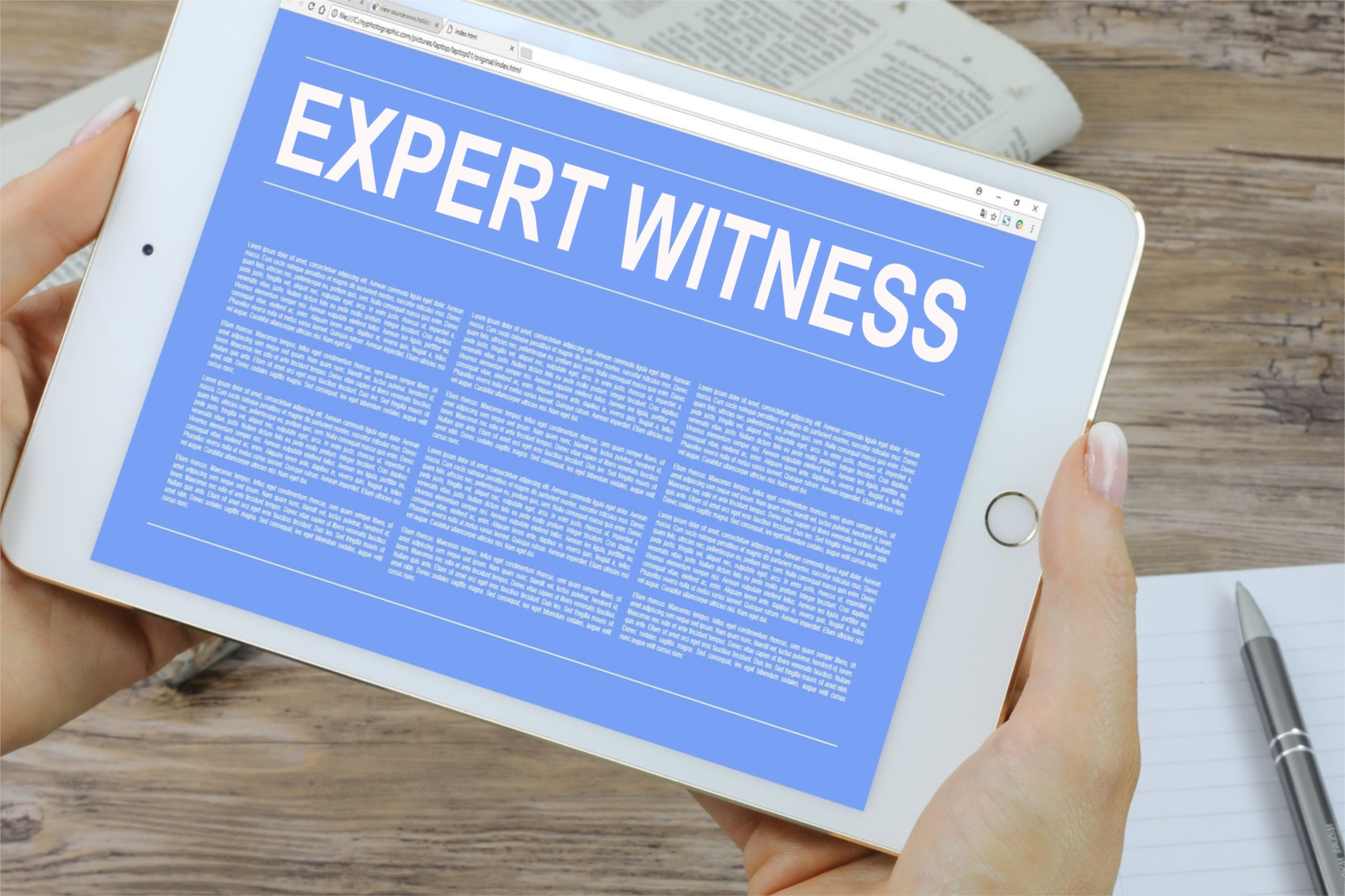 A picture of a woman holding a tablet with Expert Witness written on the screen.