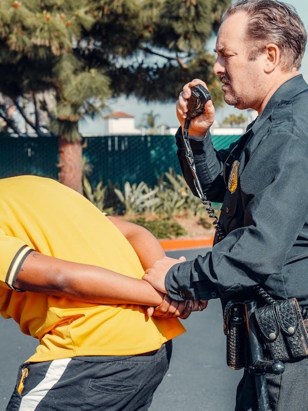 Photograph of an individual being arrested by a law enforcement officer.