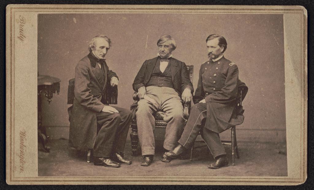 Photograph of the three prosecutors for the Lincoln assassination trial sitting in wooden chairs